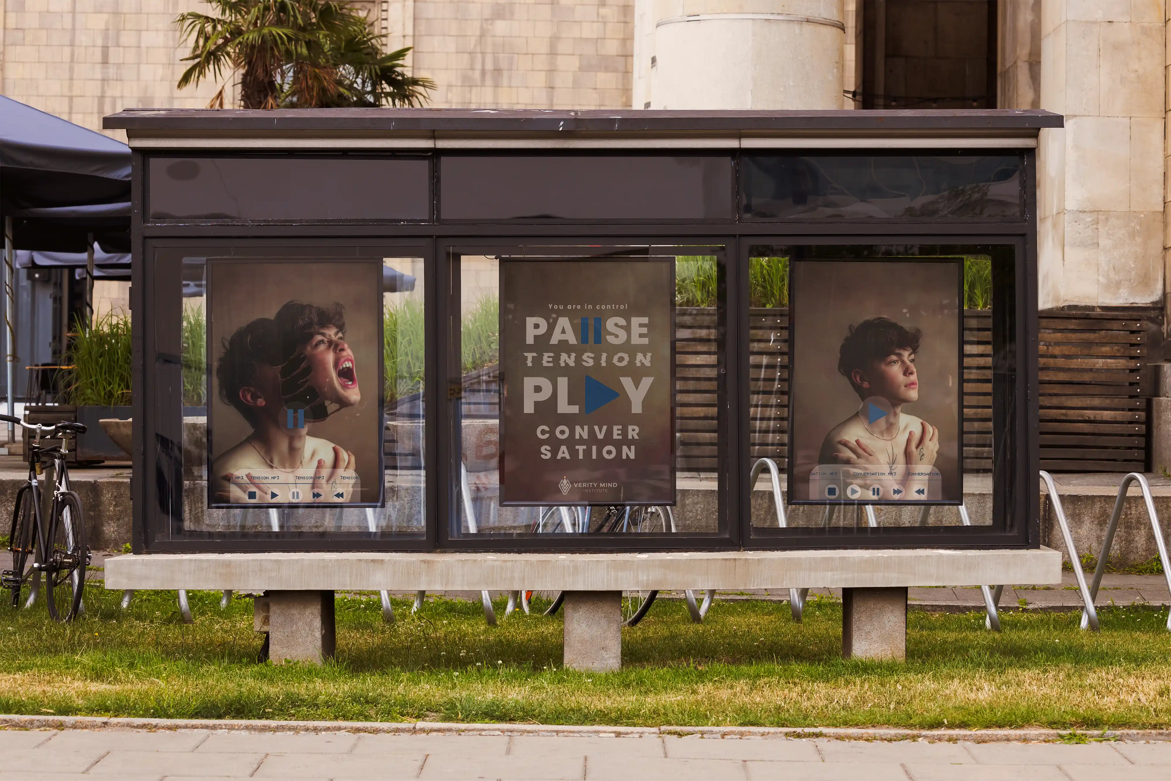 Campaign poster illuminated inside a city bus station shelter