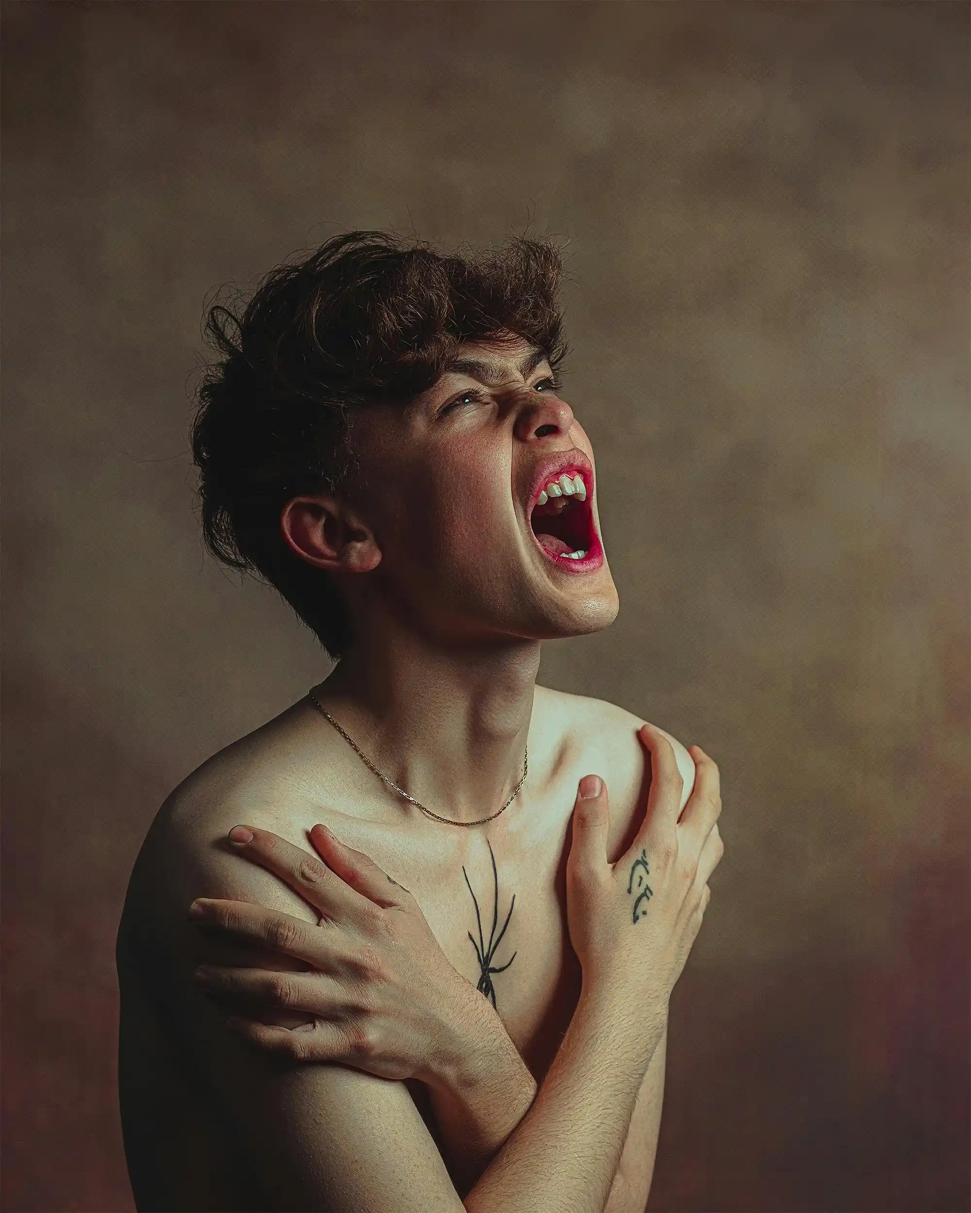Original emotional portrait of a young man screaming
